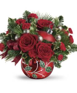 red roses and greens in red ornament vase