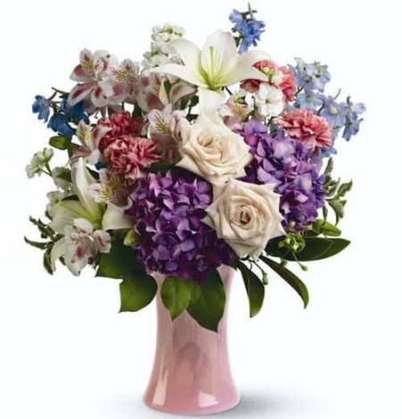 Celebrate something special with this marvelous mix of fresh flowers in shades of white, purple, pink and blue.