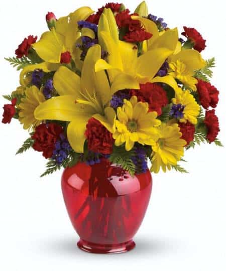 Arranged in a charming red ginger jar vase, this gorgeous gift of golden lilies and yellow daisies