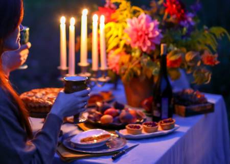 buffet of food on table with candlers and flowers in a vase
