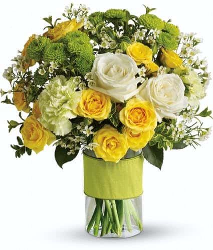 You could call or email that special someone, but why not put your feelings into flowers? She'll love this elegant array of white and yellow roses and other favorites in a stylish cylinder vase. She'll want to thank you in person.