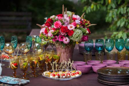 Pink floral arrangement on food table
